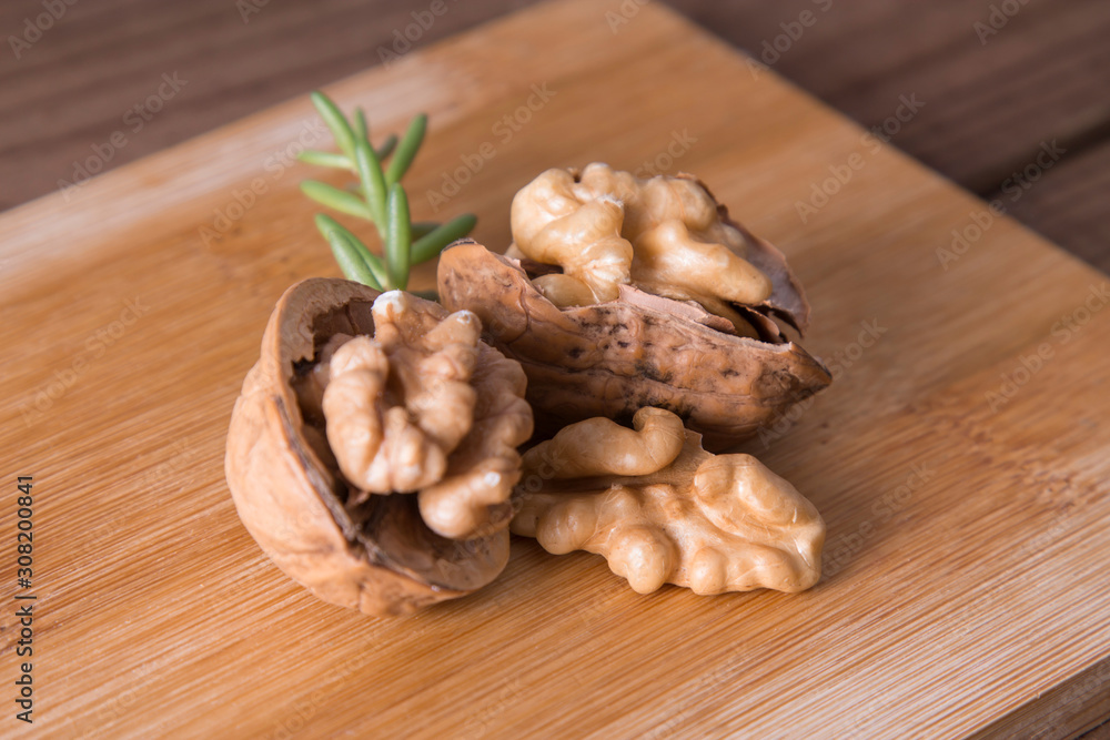 dried fruits, open nuts on wood