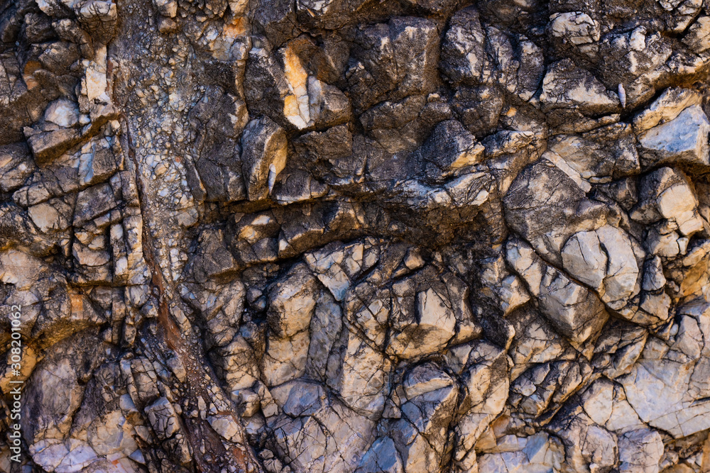 Natural old cracked colored brown stone, texture, background. Natural old cracked colored brown stone, texture, background.
