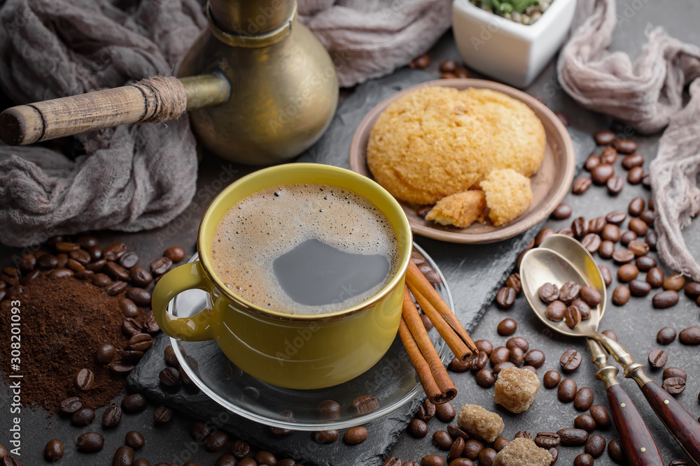 Coffee in a cup and saucer on an old background. Coffee in a cup and saucer on an old background.