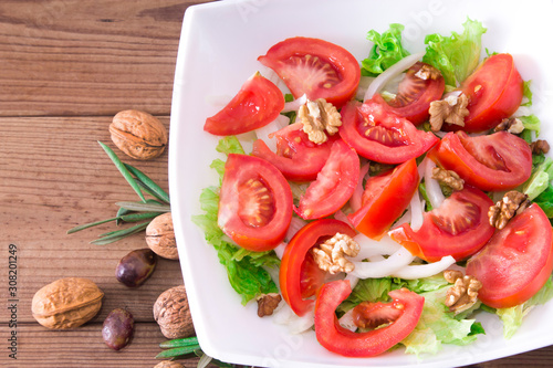 lettuce, tomato and walnut salad diet and food concept