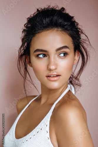 portrait of beautiful model on a pink background in the studio