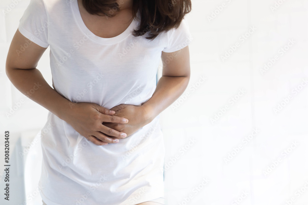 Close up woman stomachache with toilet in the morning, health care concept, selective focus Close up woman stomachache with toilet in the morning, health care concept, selective focus