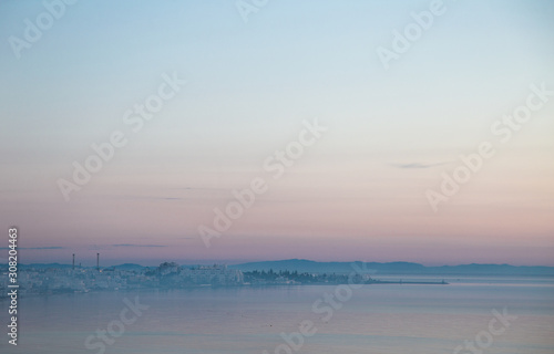 Early morning misty view of coastal line of Tunisian city El Kantaoui cityline. Horizontal color photography.