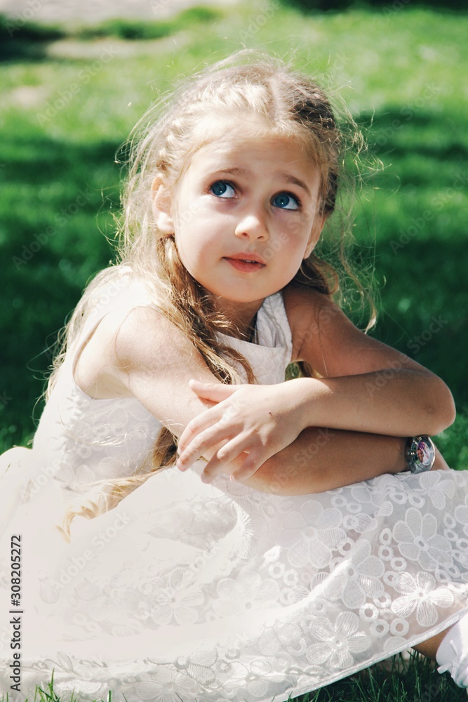 Portrait of little caucasian girl wearing white princess dress for celebration event