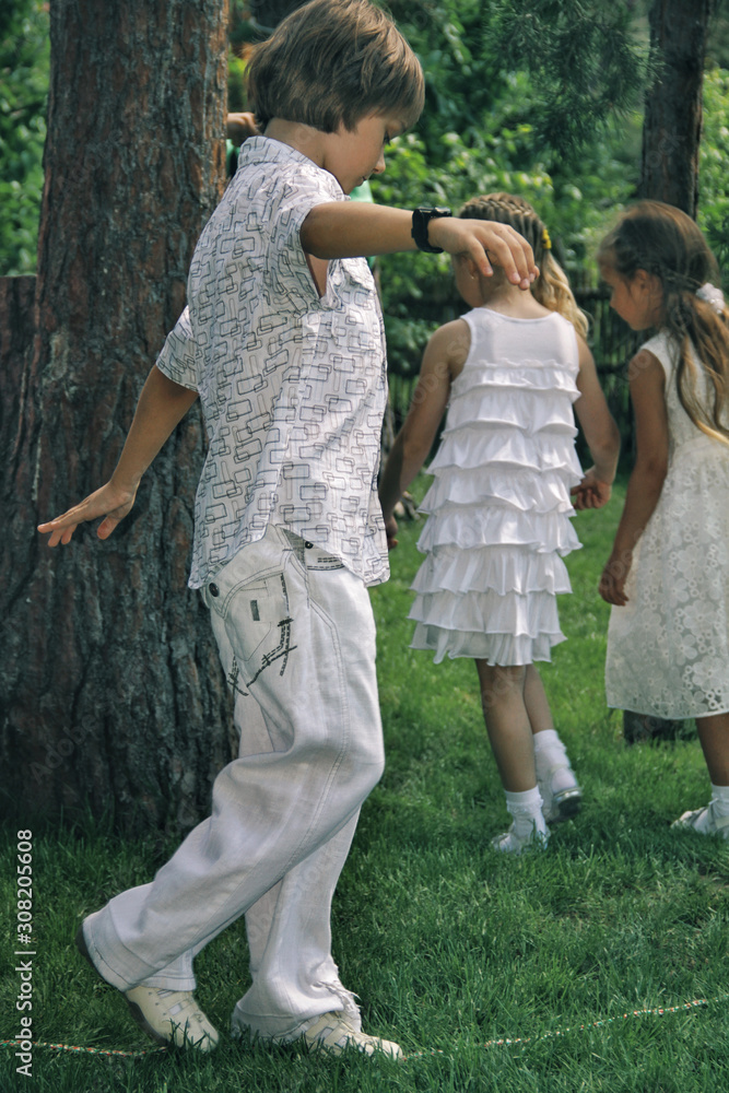 Portrait of little caucasian kids in casual clothes playing in home garden