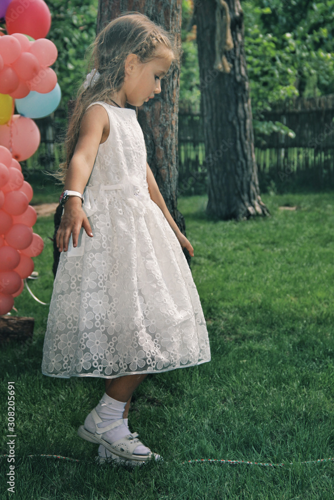 Portrait of little caucasian girl wearing white princess dress for celebration event