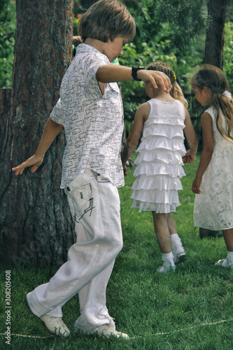 Obraz na płótnie Portrait of little caucasian kids in casual clothes playing in home garden w salonie