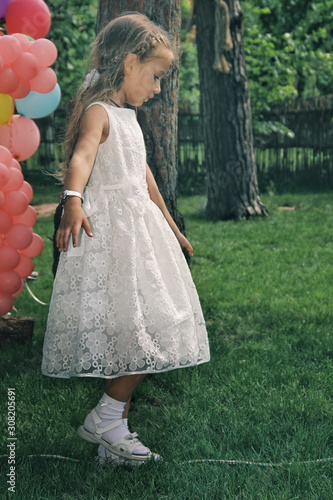 Obraz na płótnie Portrait of little caucasian girl wearing white princess dress for celebration event w salonie