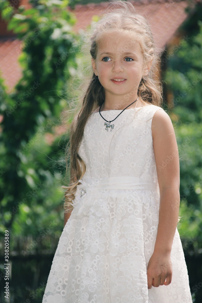 Portrait of little caucasian girl wearing white princess dress for celebration event