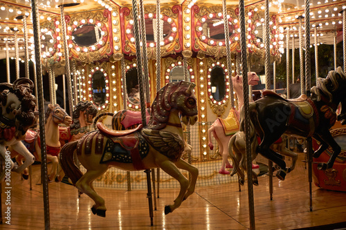 Horses on a merry-go-round with lights on a Christmas night