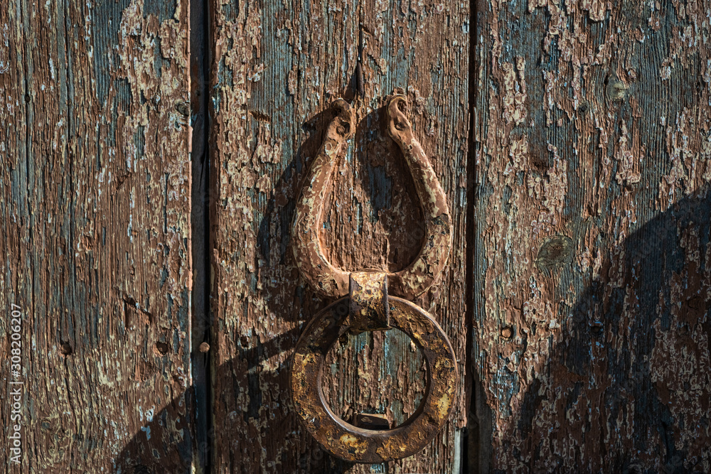 Closeup view of old weathered wooden door. Horizontal color photography.