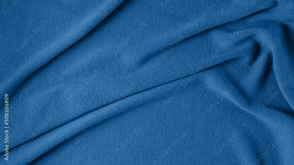 Pure natural cashmere is toned in a fashionable color, classic blue. Abstract background in a trending color Pure natural cashmere is toned in a fashionable color, classic blue. Abstract background in a trending color