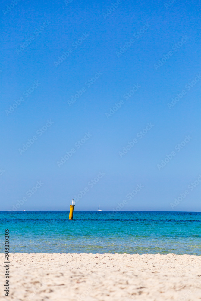 Beautiful marine landscape of soft peaceful waves of sea water, sunny clear blue sky. Vertical color photography.