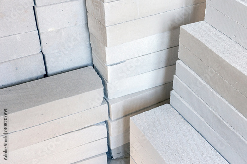 Stack of white lightweight concrete block, used for construction wall.