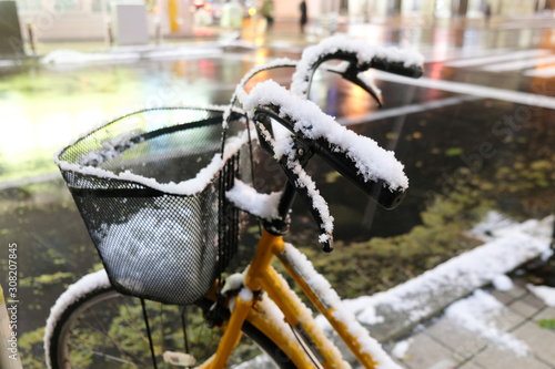 Bike covered with snow in the city. Winter in Hokkaido, Japan