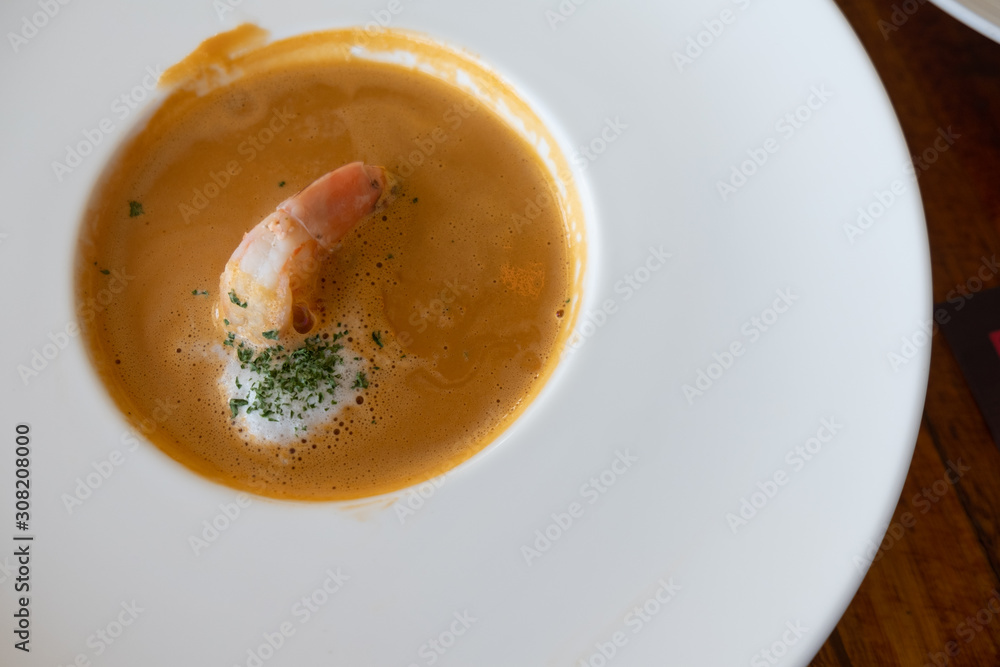 Shrimp cream soup with shrimps, parsley in plate Shrimp cream soup with shrimps, parsley in plate