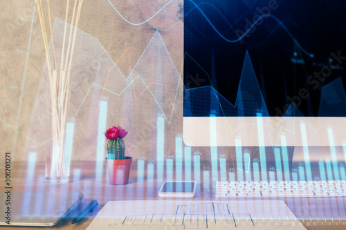 Forex Chart hologram on table with computer background. Multi exposure. Concept of financial markets. © peshkova