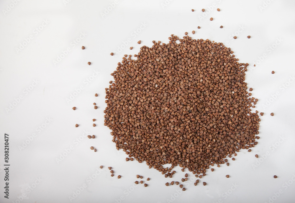 Buckwheat seeds closeup isolated on white background. Copy spaes. Buckwheat seeds closeup isolated on white background. Copy spaes.