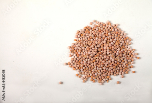 dried yellow raw peas scattered on a white background. Copy spaes. Horizontally