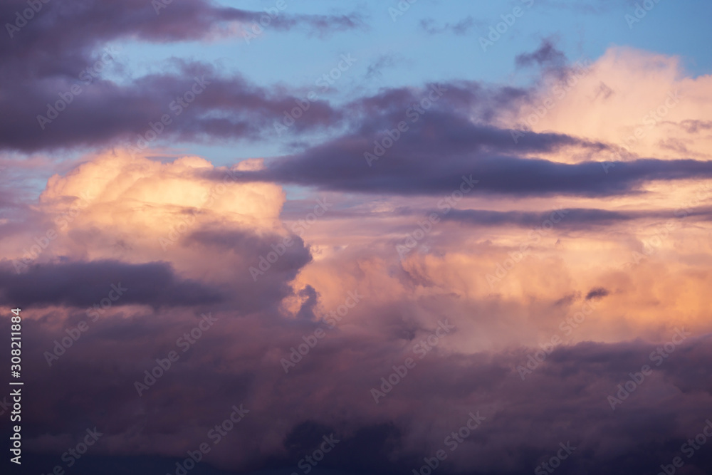 Dramatic sunrise, sunset pink violet sky with clouds background texture
