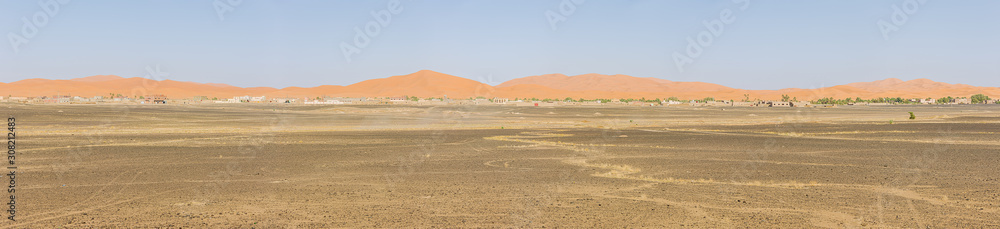 Panorama of the sand dunes of Erg Chebbi with Merzuga in the foreground Panorama of the sand dunes of Erg Chebbi with Merzuga in the foreground