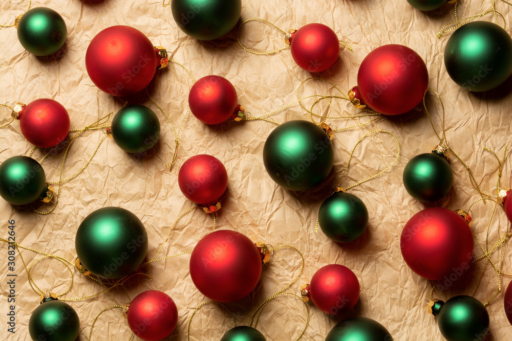 Group of big and small shiny Christmas balls of red and green colors on craft paper background Group of big and small shiny Christmas balls of red and green colors on craft paper background
