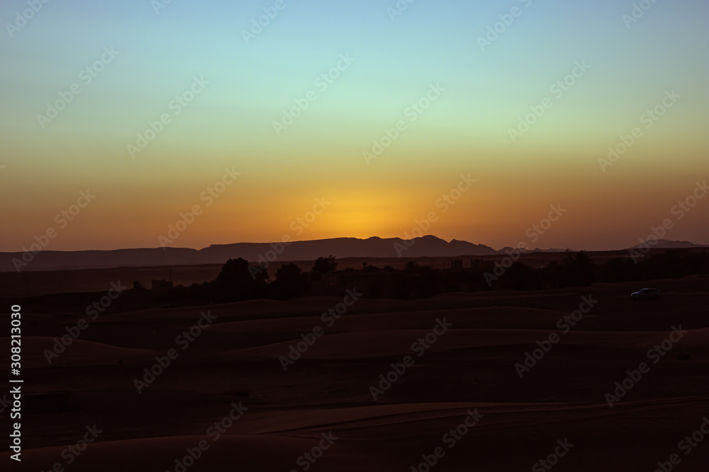 Orange halo above the setting sun seen from Erg Chebbi