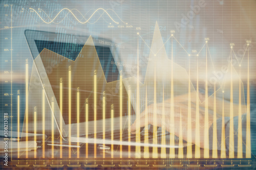 Double exposure of businessman's hands with laptop and stock market graph background. Concept of research and trading. © peshkova