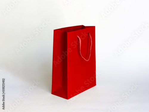 Red paper bag mock up with handles on gray background. High resolution.