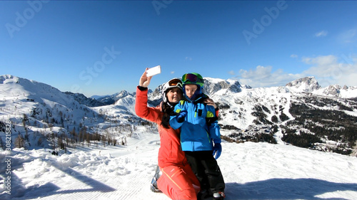 Young mother makes selfie with her son. Family Skiing Holidays in the Austrian Alps.