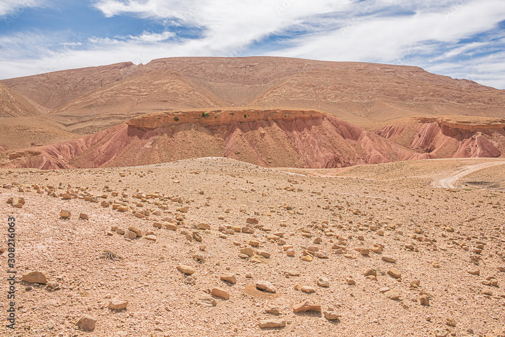 Eroded red cuestas with deep crevasses near the Dades Gorges