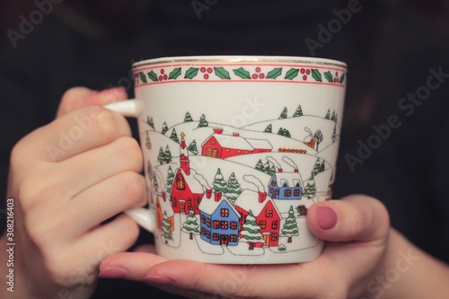 Closeup of a woman holding a Christmas cup.