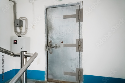 Old metal door locked in an industrial room