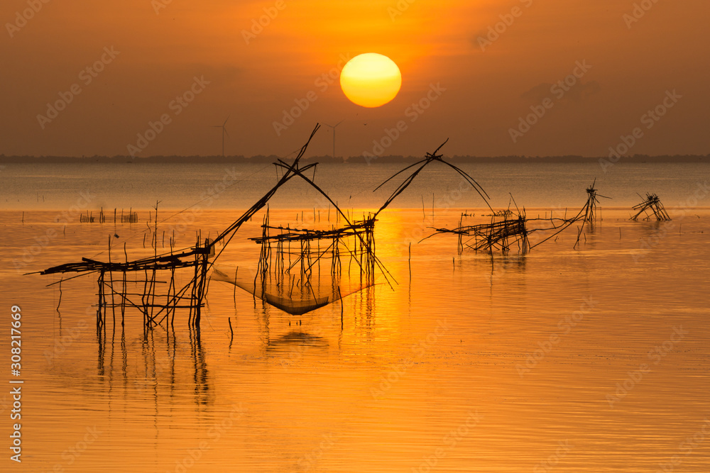 Sunrise with fishing trap in Pak Pra Talay Noi sea Phatthalung south of Thailand