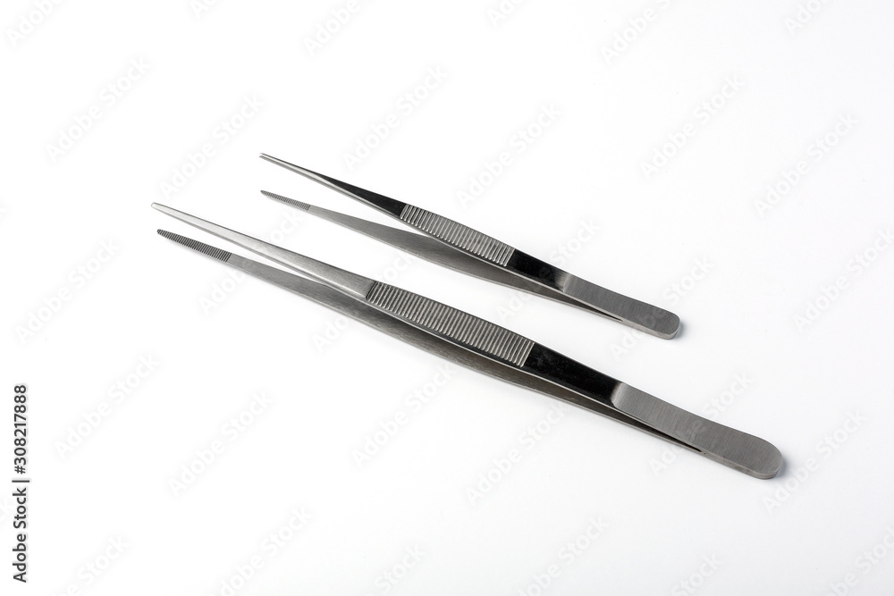 Set of two stainless steel tweezers on white background