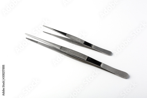 Set of two stainless steel tweezers on white background