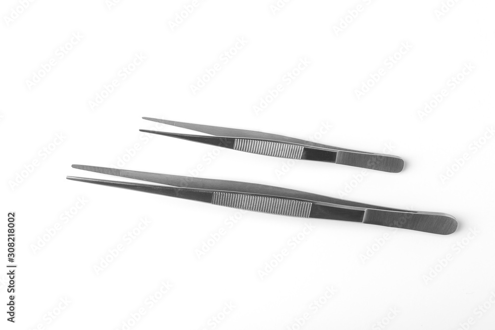 Set of two stainless steel tweezers on white background Set of two stainless steel tweezers on white background