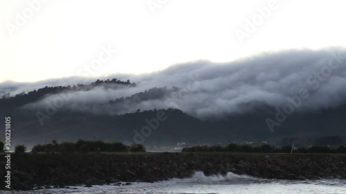 Fog moving along the top hill, Greymount, south island, New Zeland photo