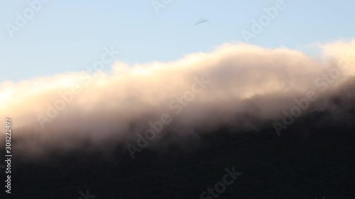 Fog moving along the top hill, Greymount, south island, New Zeland photo