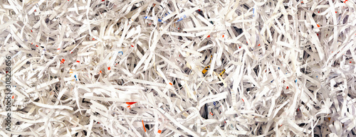 Close Up of Shredded Paper from a paper shredder. Paper Trimmings Waste. Cut Paper strips.