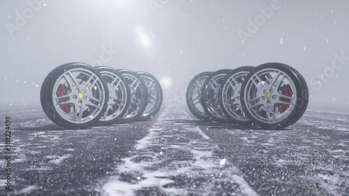 Winter tires on a background of snowstorm, snowfall and slippery winter road. Winter tires concept. Wheel replacement. Road safety concept. 4k 3d animation with falling snow
