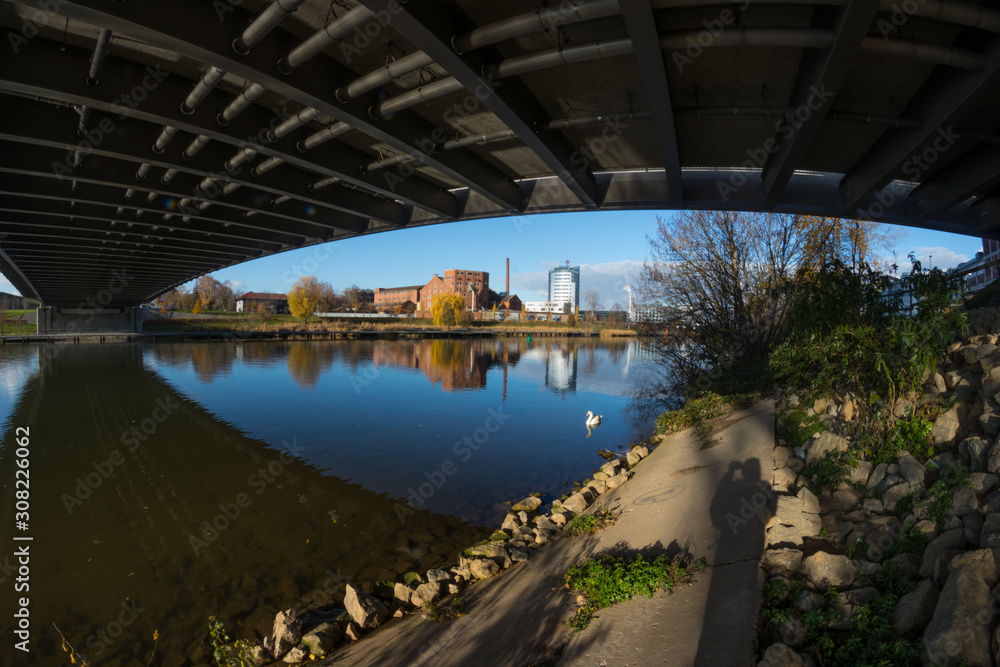 View from under the bridge next to the river View from under the bridge next to the river