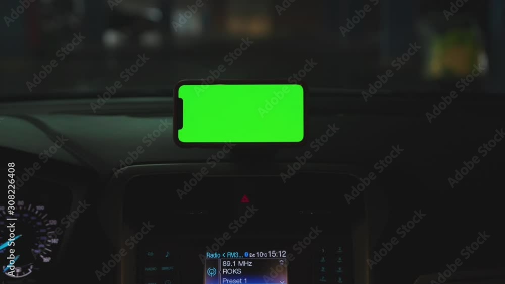 Hands man drive car smartphone with horizontal green screen display on the dashboard application technology transport inside phone business car phone cell device screen digital close up slow motion Hands man drive car smartphone with horizontal green screen display on the dashboard application technology transport inside phone business car phone cell device screen digital close up slow motion