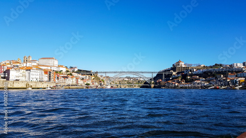 Fototapeta Naklejka Na Ścianę i Meble -  Porto Bridge with blue sky and the river