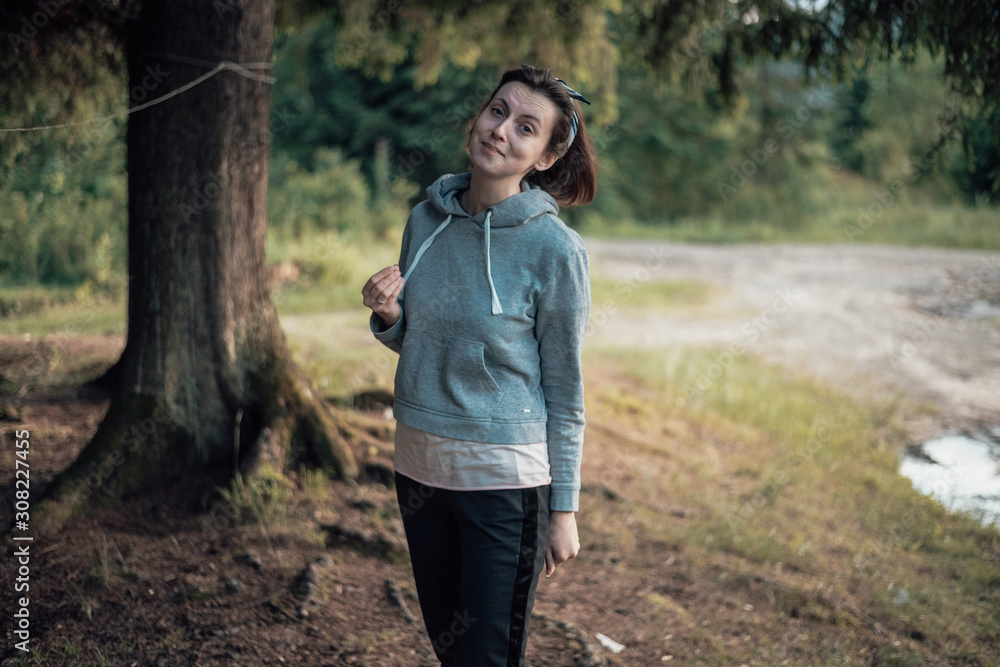 beautiful girl traveling in the woods. Stand in the forest beautiful girl traveling in the woods. Stand in the forest