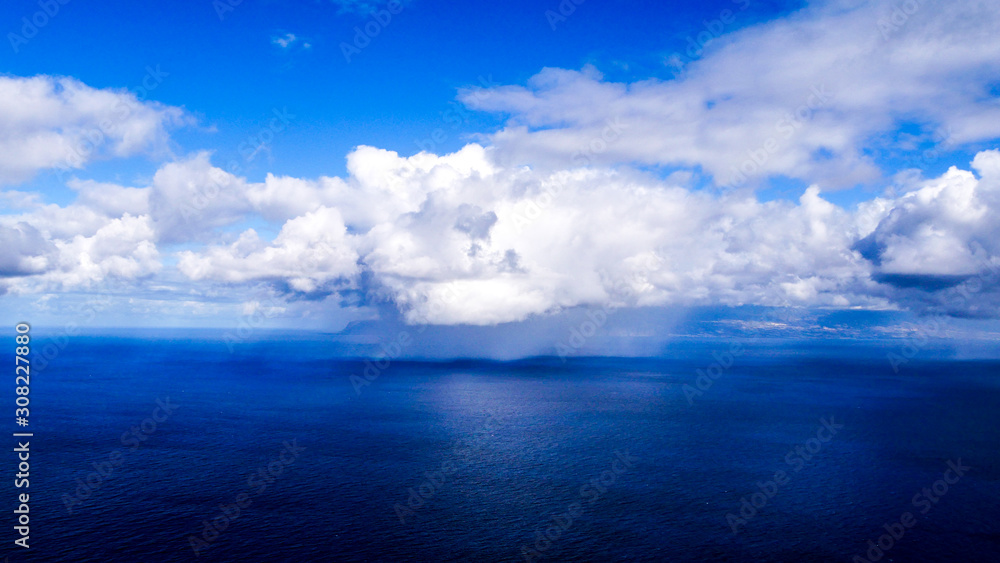 Rainclouds on the open atlantic with blue sky