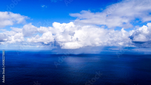 Rainclouds on the open atlantic with blue sky