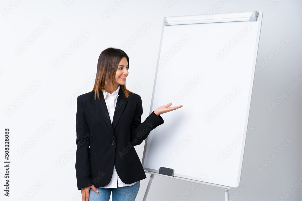 Young woman giving a presentation on white board giving a presentation on white board Young woman giving a presentation on white board giving a presentation on white board