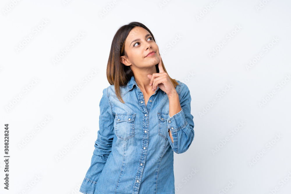 Young woman over isolated white background thinking an idea while looking up Young woman over isolated white background thinking an idea while looking up