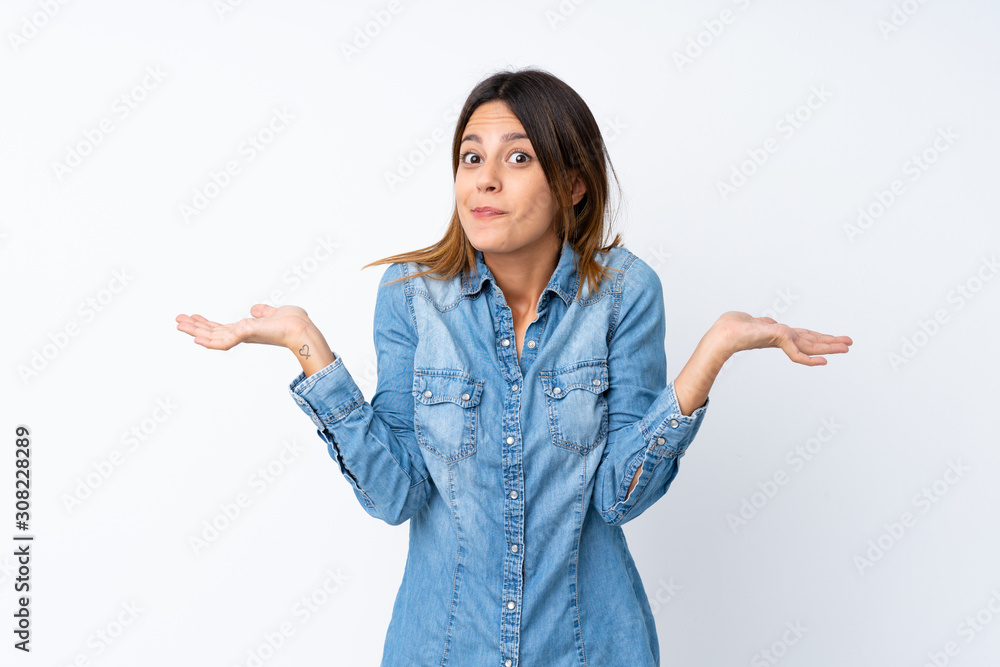 Young woman over isolated white background having doubts while raising hands Young woman over isolated white background having doubts while raising hands